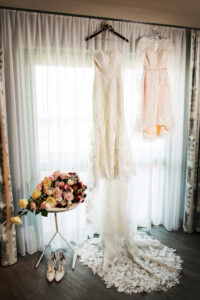 Elegant Garden Wedding, Brides Lace Fitted Wedding Dress Hanging, Red, Pink and Yellow Roses with Berries and Greenery Floral Bouquet | Tampa Bay Wedding Photographer Limelight Photography | Wedding Florist Lemon Drops