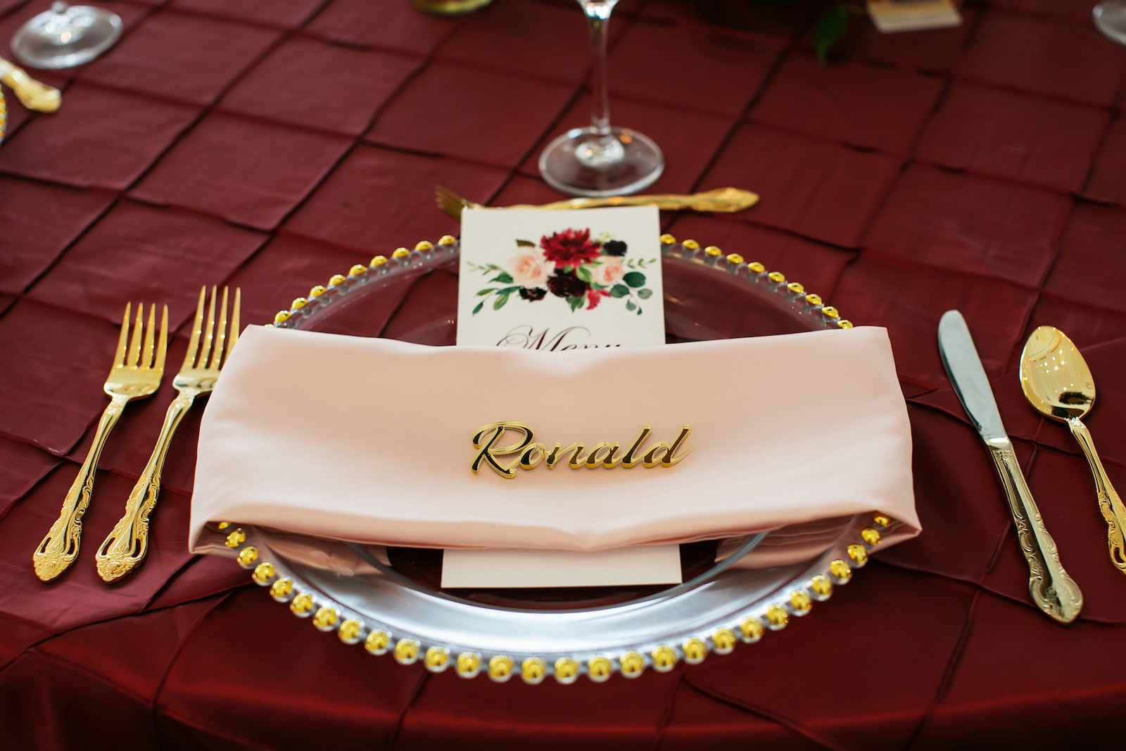 Elegant Garden Burgundy Ballroom Wedding Reception Decor, Burgundy Table Linen, Gold Chargers and Flatware with Lasercut Name Place Setting| St. Petersburg Rentals Outside the Box Event Rentals