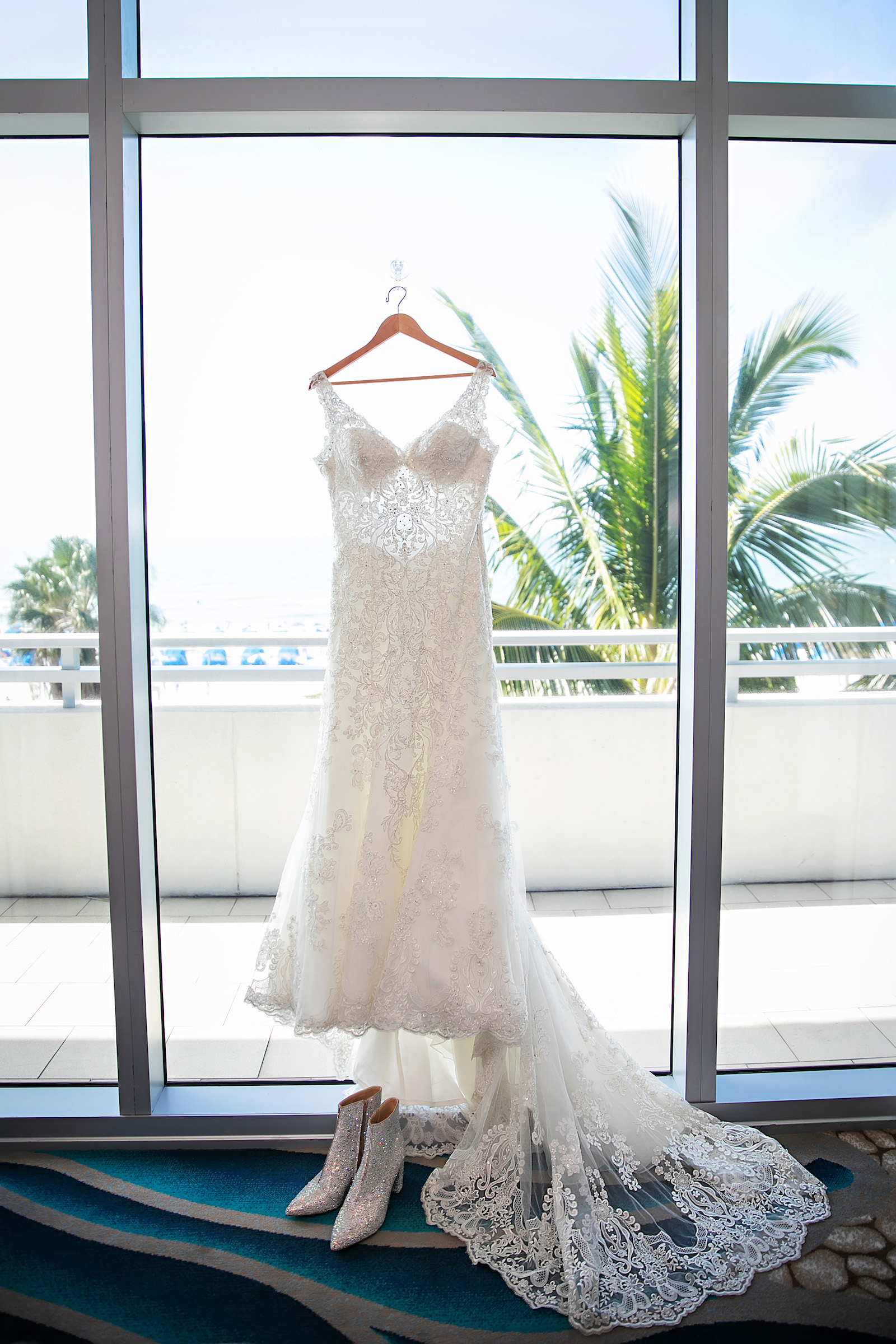 Lace Illusion Wedding Gown with Long Train on Hanger Portrait | Florida Wedding Photographer Limelight Photography