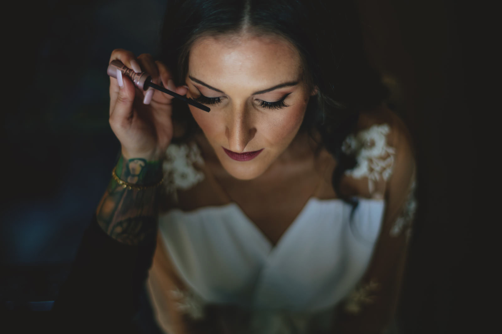 Dark and Moody Portrait of Bride Getting Makeup Done