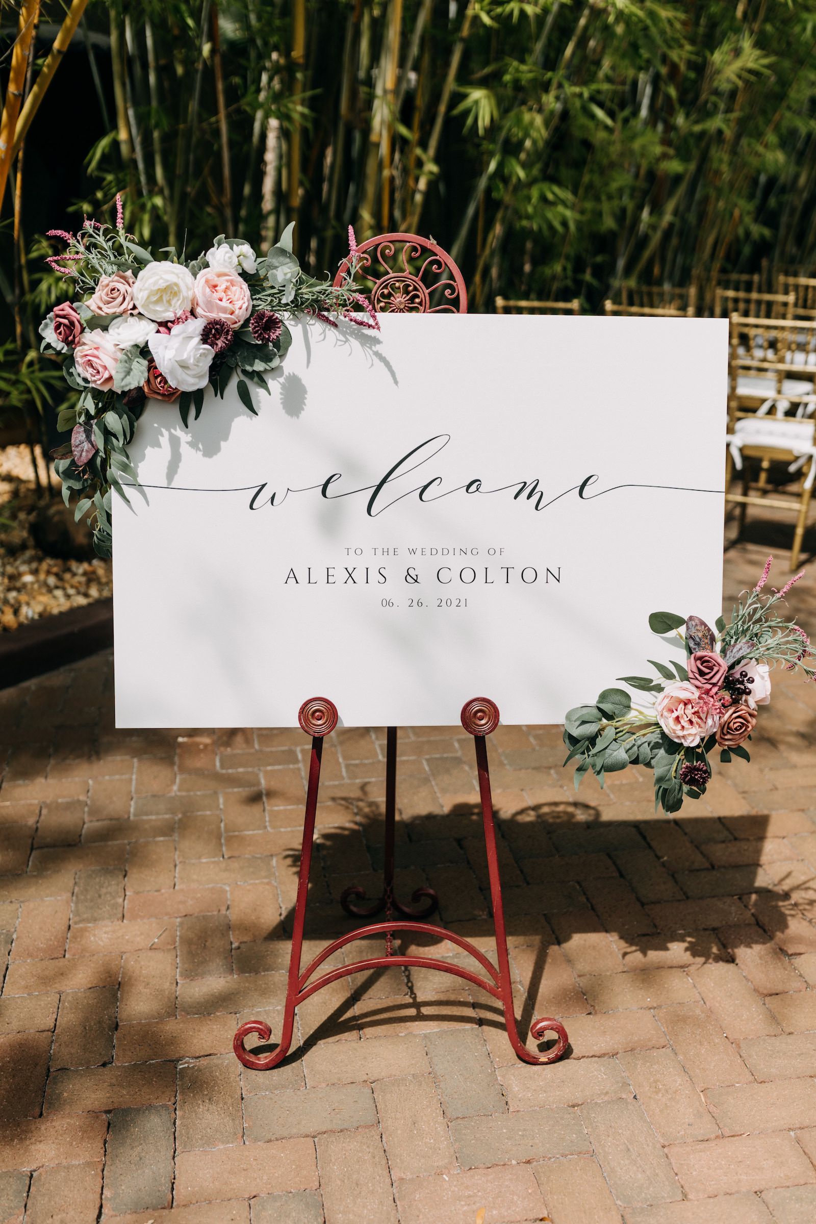 Wedding Welcome Sign in White with Black Cursive Lettering and Floral and Greenery Corner Detail Wedding Décor
