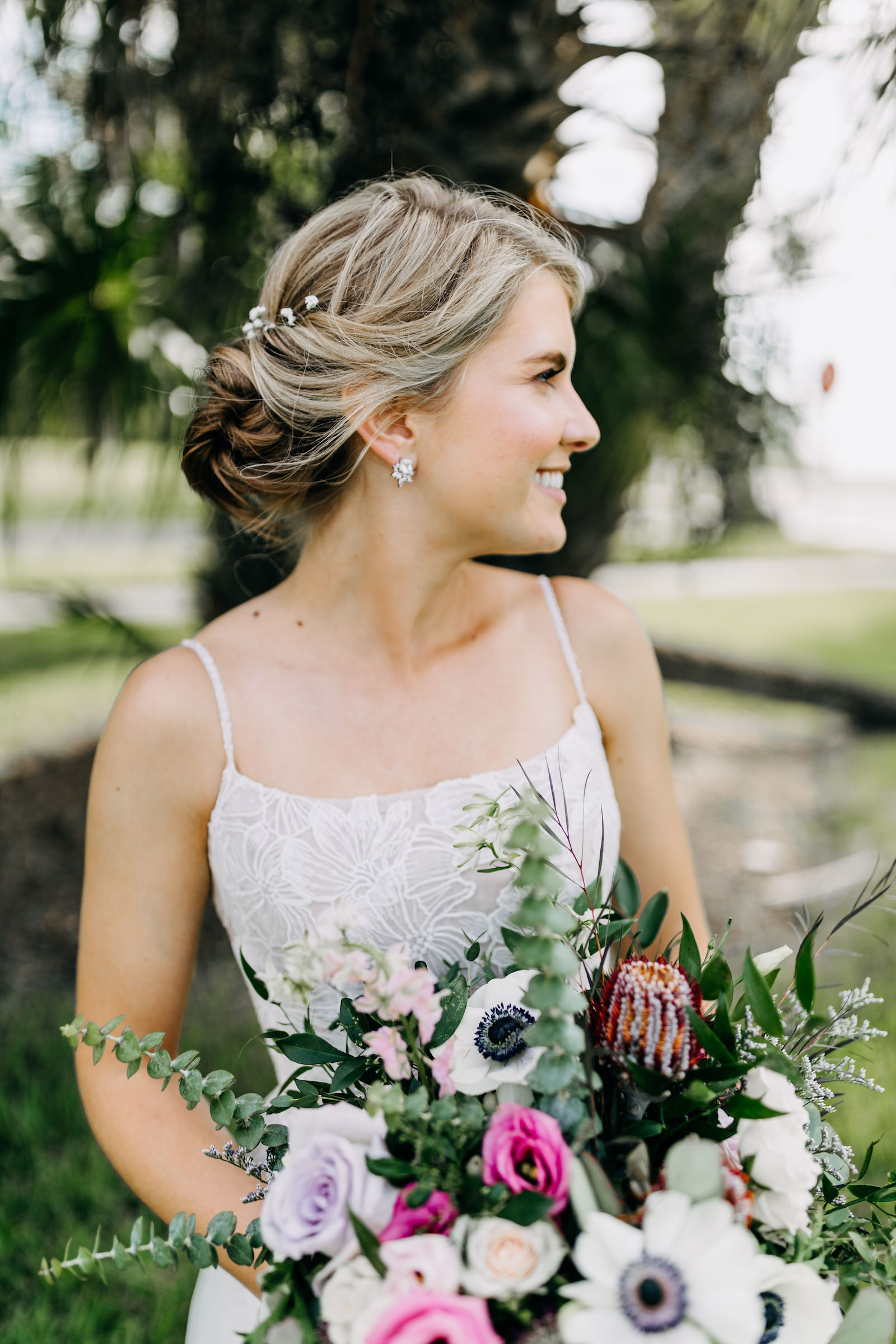 Bride with Braided Updo Wearing Lace Straight Neckline Wedding Dress Holding Lush Floral Bouquet, White Anemone, Pink and Purple Roses with Greenery | Tampa Bay Wedding Photographer Amber McWhorter Photography | Wedding Florist Leaf It To Us