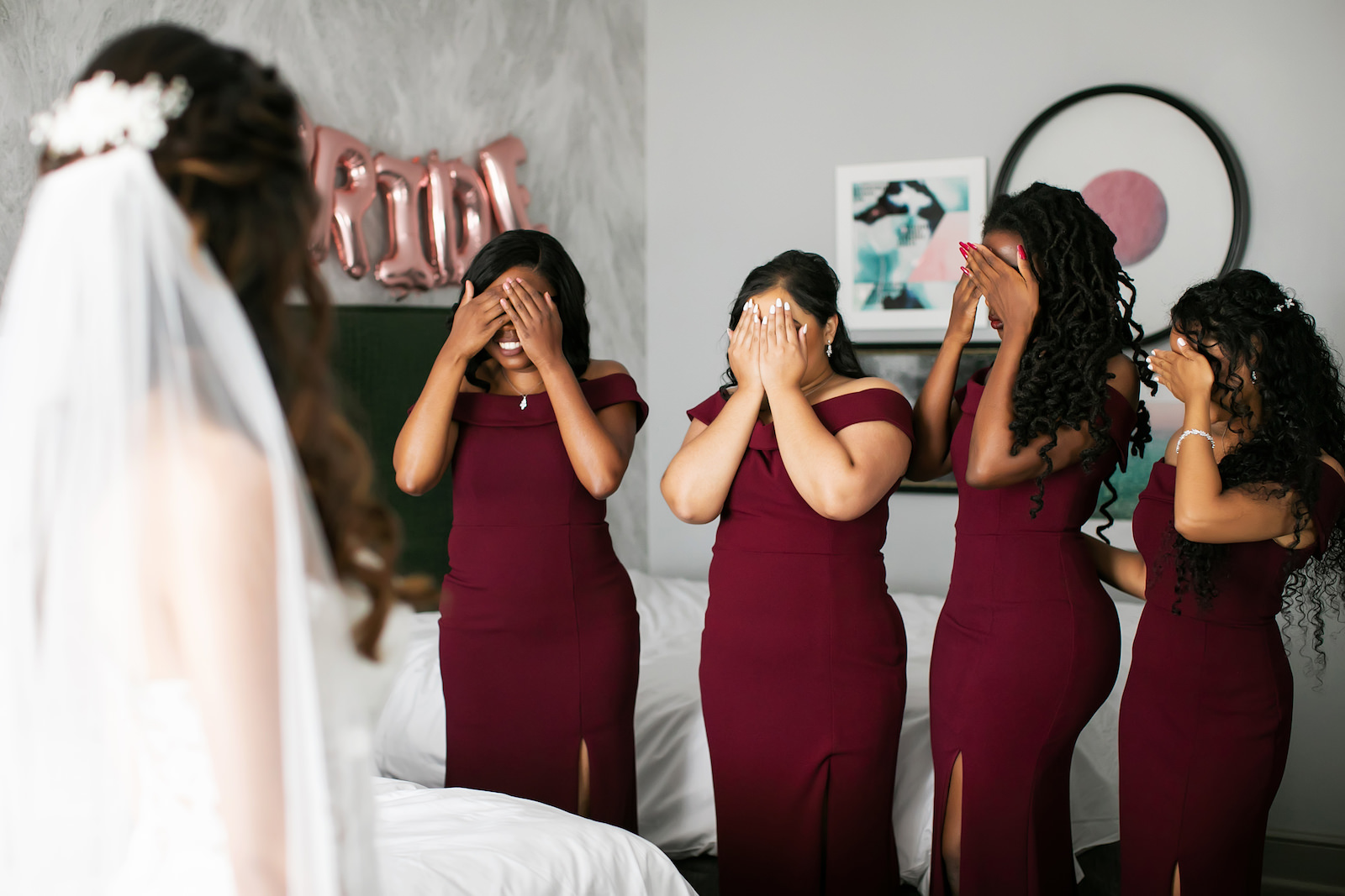 Bridesmaids Wearing Matching Off the Shoulder Burgundy Dresses First Look with Bride | Tampa Bay Wedding Photographer Limelight Photography | Wedding Hair and Makeup Femme Akoi Beauty Studio
