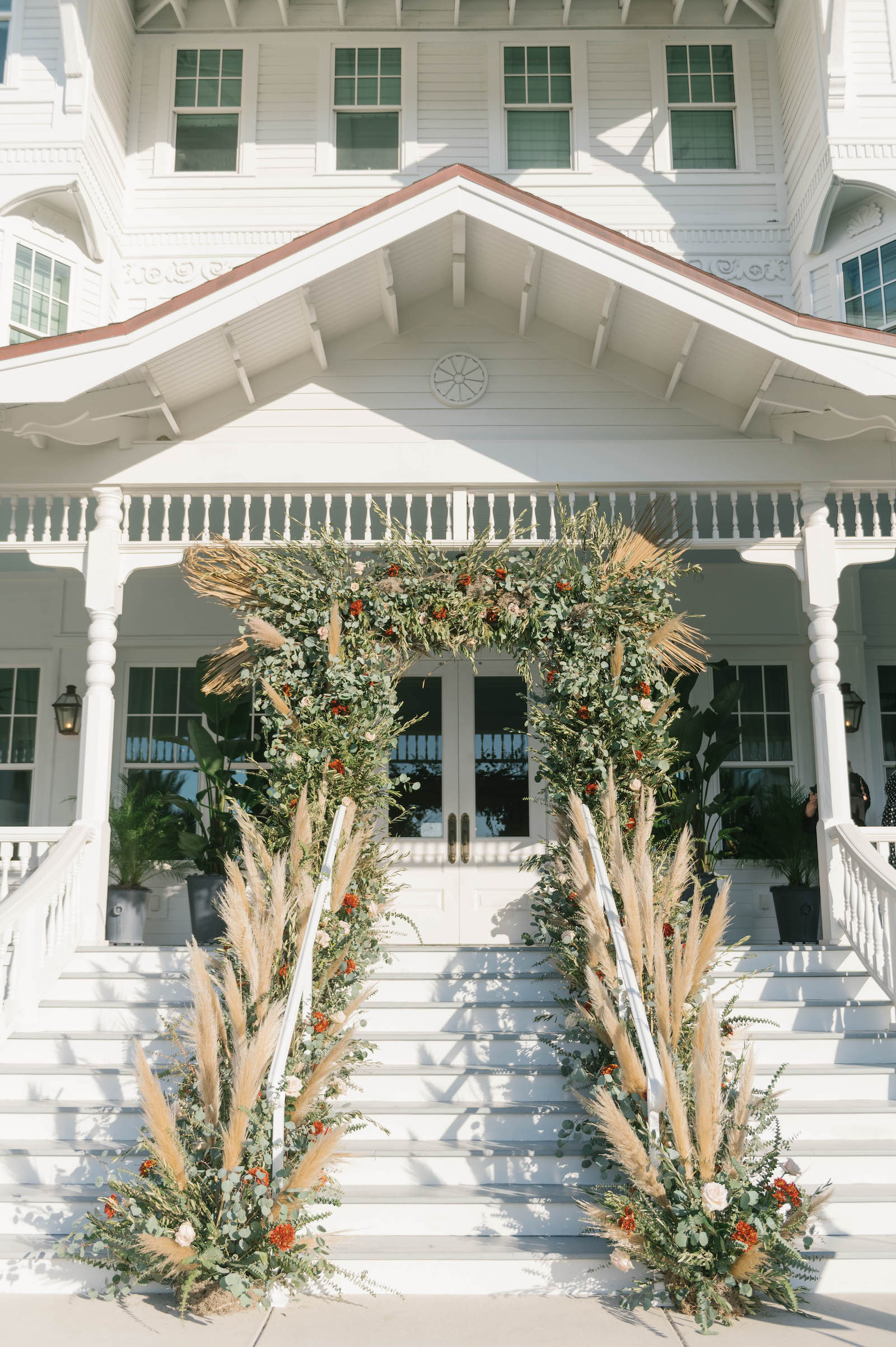 Boho Garden Wedding Ceremony, Lush Greenery and Floral Arch with Pampas Grass Arrangements, String Lights | Tampa Bay Wedding Planner Parties A'la Carte | Florida Wedding Venue Belleview Inn