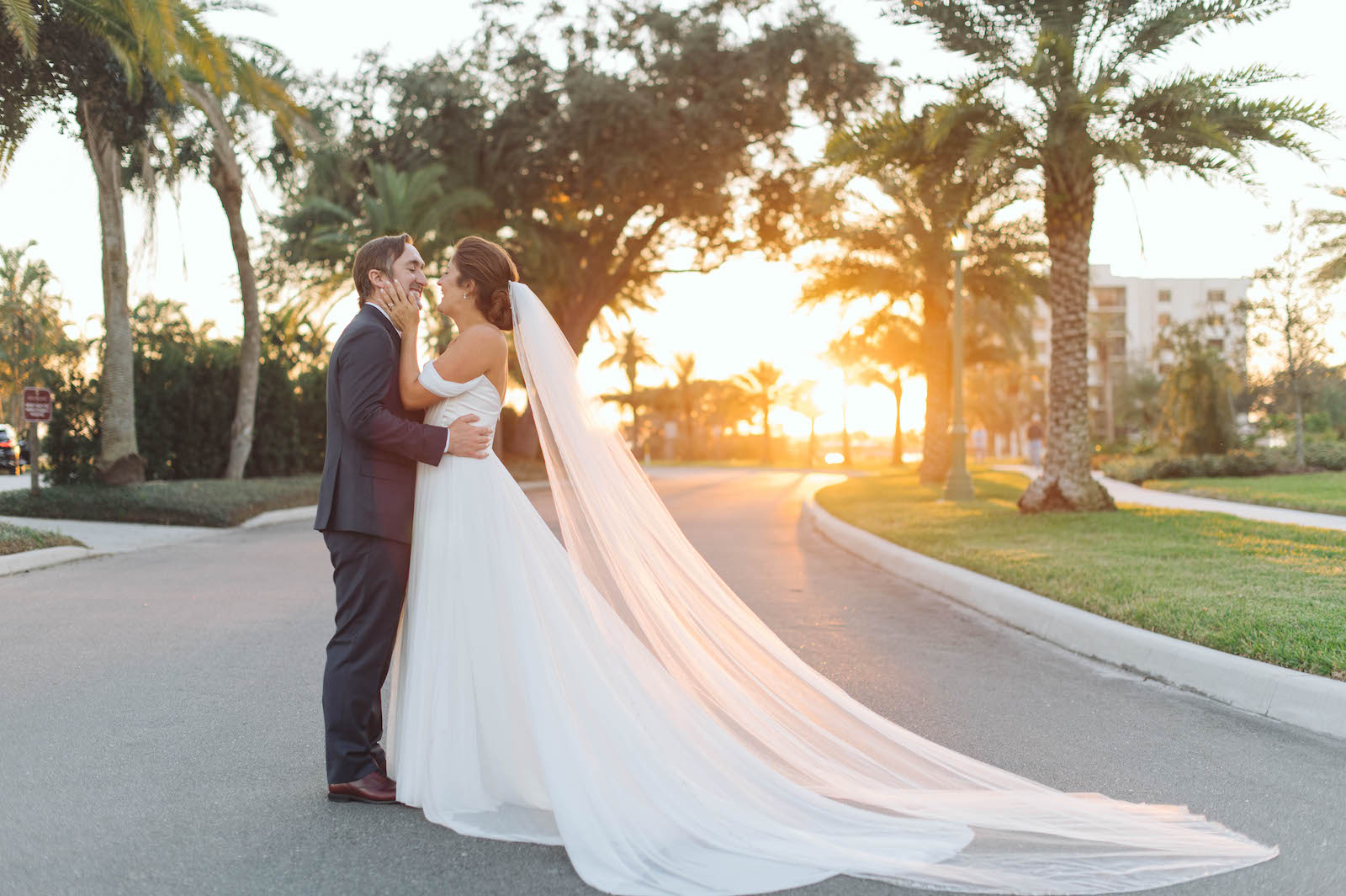 Boho Garden Wedding, Bride Wearing Off the Shoulder A-Line Wedding Dress and Full Length Veil with Groom Sunset Wedding Photo