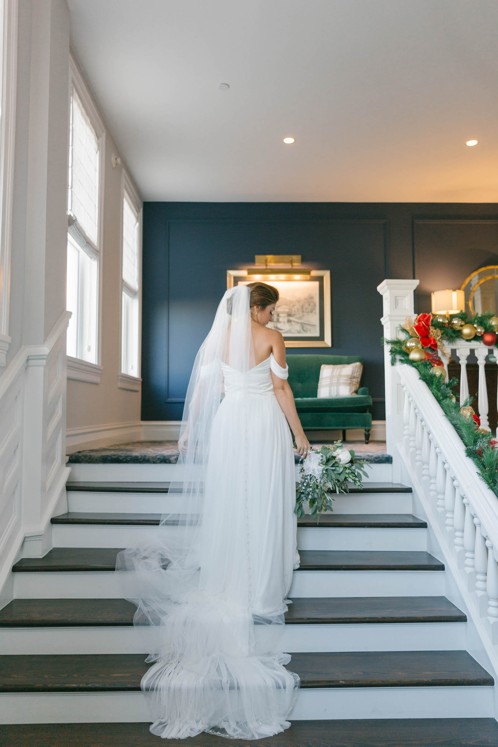 Bride Wearing Off the Shoulder Wedding Dress and Full Length Veil on Staircase of Florida Wedding Venue Belleview Inn