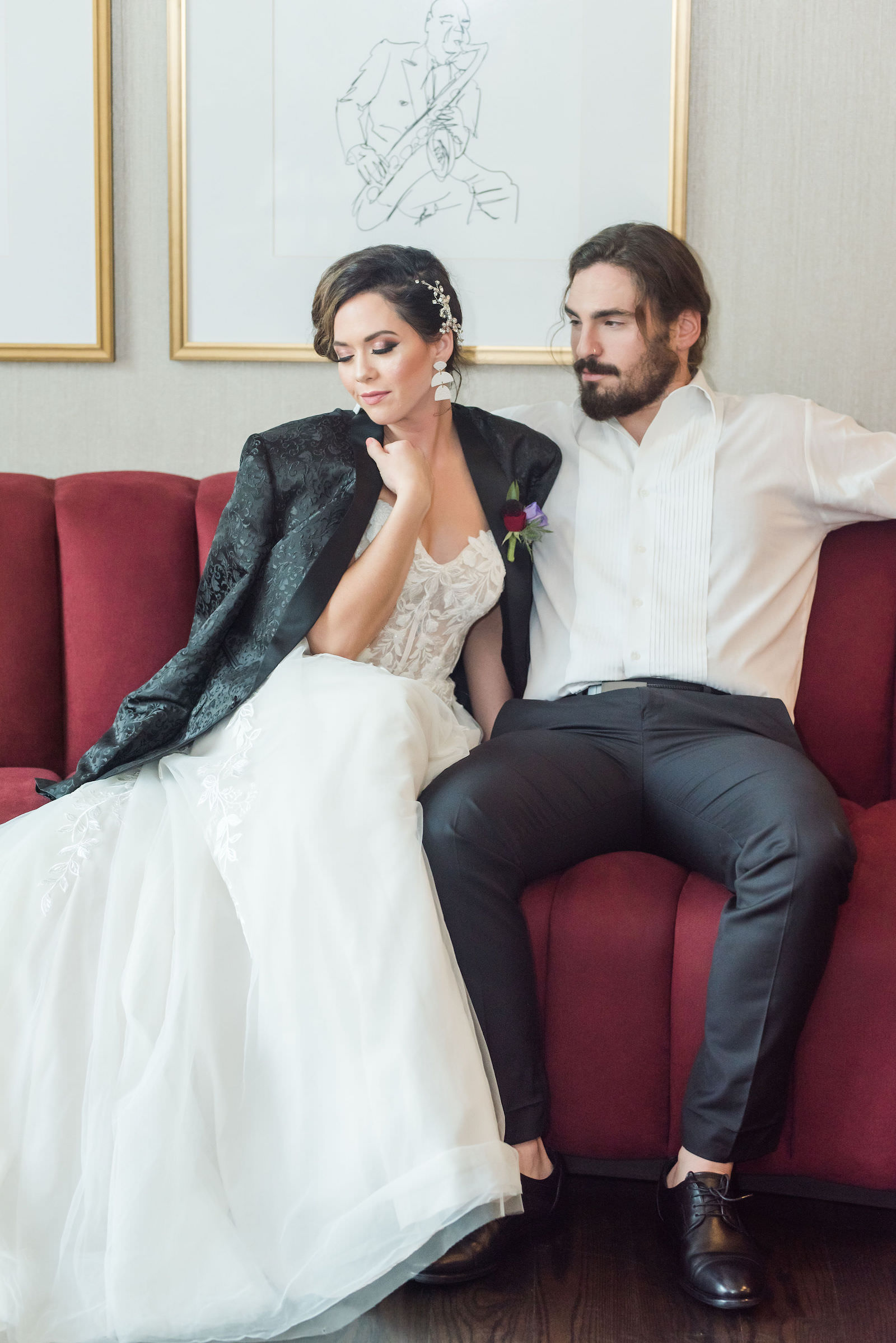 Modern Rock N Roll Bride Wearing Groom Custom Leather Suit Jacket Sitting on Red Tufted Couch with Groom | Tampa Bay Wedding Photographer Amanda Zabrocki Photography