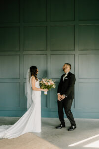 Modern Boho Bride and Groom First Look Wedding Portrait | Dark Green Board and Batten Accent Wall | Unique South Tampa Wedding Venue Hyde House