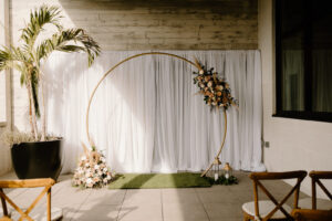 Modern Boho Wedding Ceremony Decor, Round Gold Metal Arch with Lush Floral Arrangements, Greenery Eucalyptus, Pampas Grass and Neutral Flowers, White Linen Backdrop, Wooden Crossback Chairs, Green Turf Mat | Tampa Bay Wedding Florist Iza's Flowers | Wedding Venue Hyde House