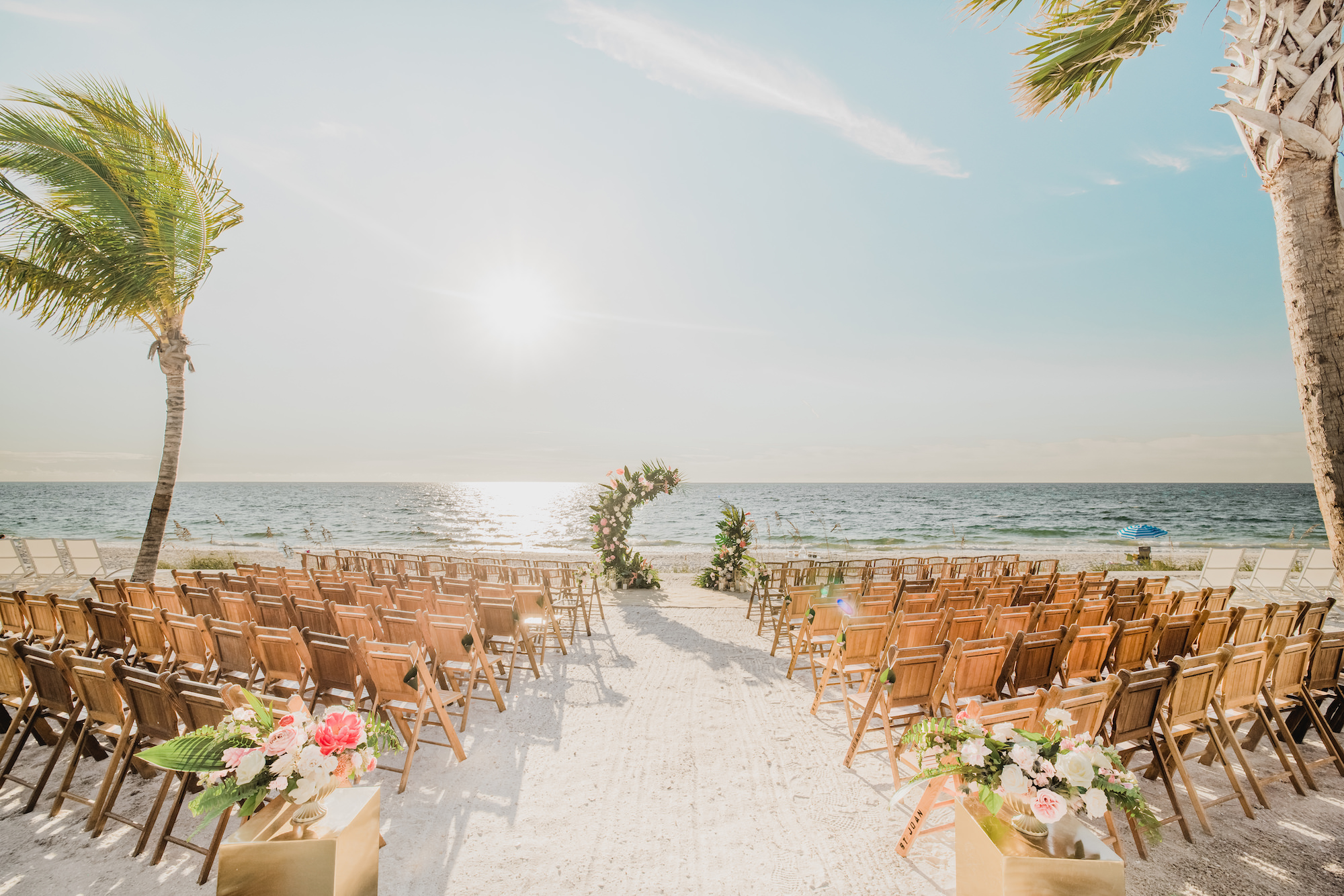 Beach Front Half Circle Arch Wooden Folding Chairs and Pink Florals with Greenery