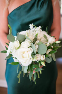 Green and Gold Christmas Wedding, Bridesmaid Holding White Roses, Eucalyptus and White Berry Floral Bouquet | Tampa Bay Wedding Photographer Carrie Wildes Photography