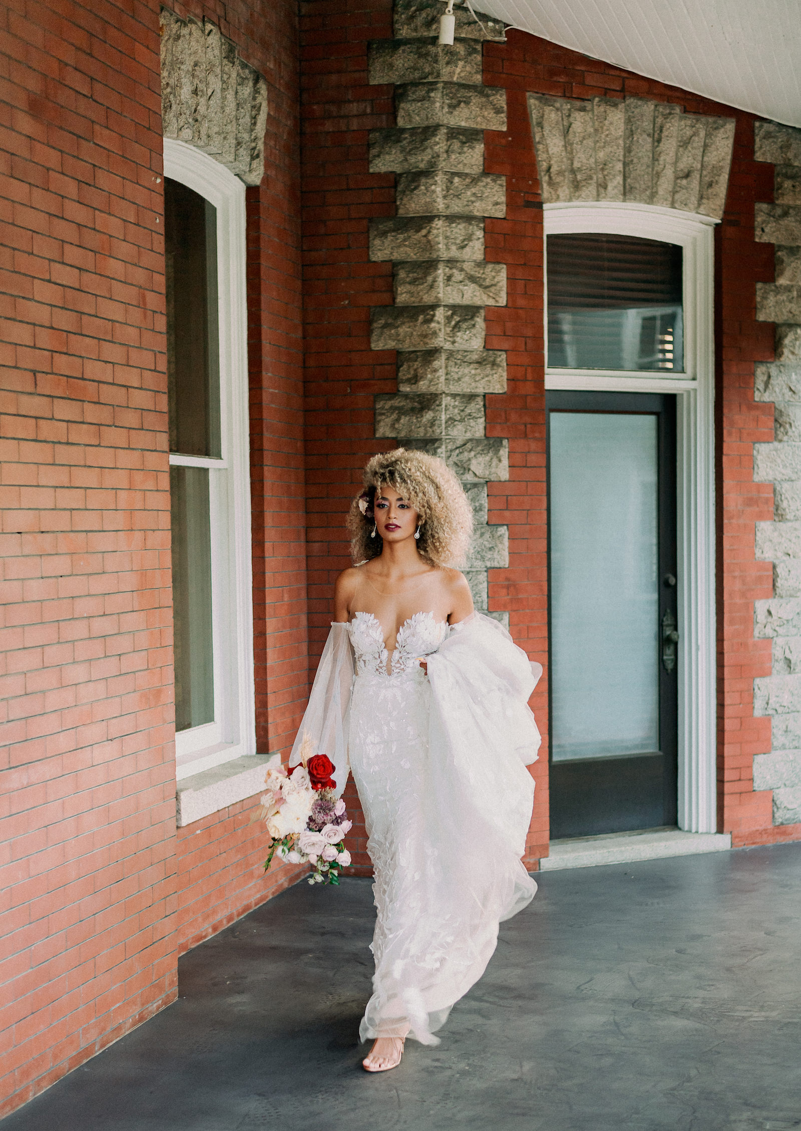 Vintage European Bride Wearing Unique Off the Shoulder Puff Long Sleeves Lace Strapless Wedding Dress Holding Organic Blush Pink and Red Floral Bouquet | Tampa Bay Wedding Photographer Dewitt for Love