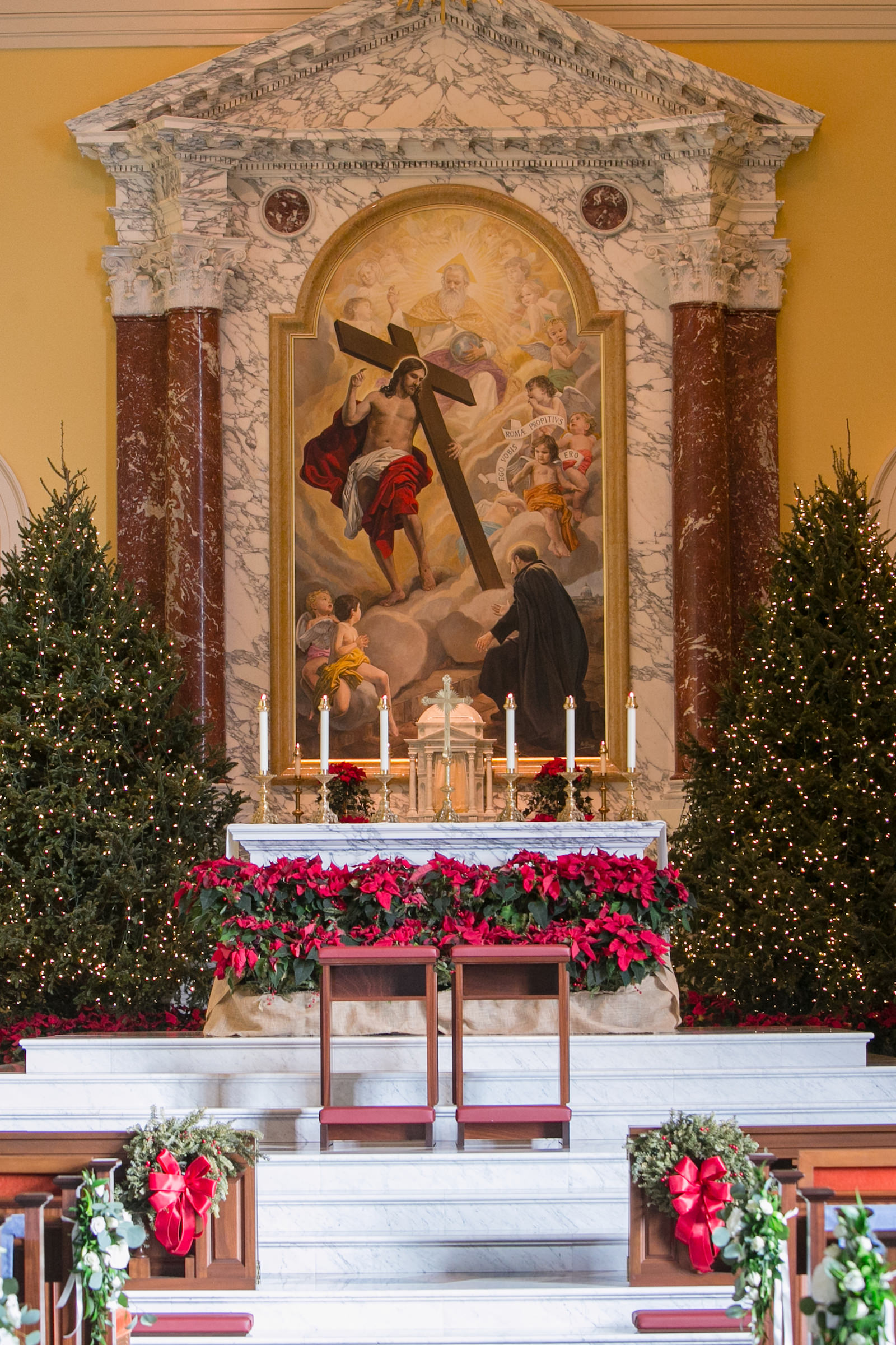 Green and Gold Christmas Wedding Decor, Pine Tree with Lights, Red Poinsettas, Candlesticks at Altar Traditional Wedding Church Ceremony | Tampa Wedding Venue Jesuit High School: Chapel of the Holy Cross