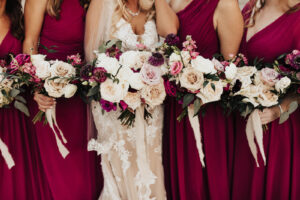 Warm Romantic Neutral Wedding, Bride Wearing Lace and Illusion with Nude Lining Wedding Dress, Bridesmaids Wearing Mix and Match Berry Dresses, Maid of Honor Wearing Champagne Dress Holding Lush White Roses, Blush Pink, Berry and Purple Floral Bouquets