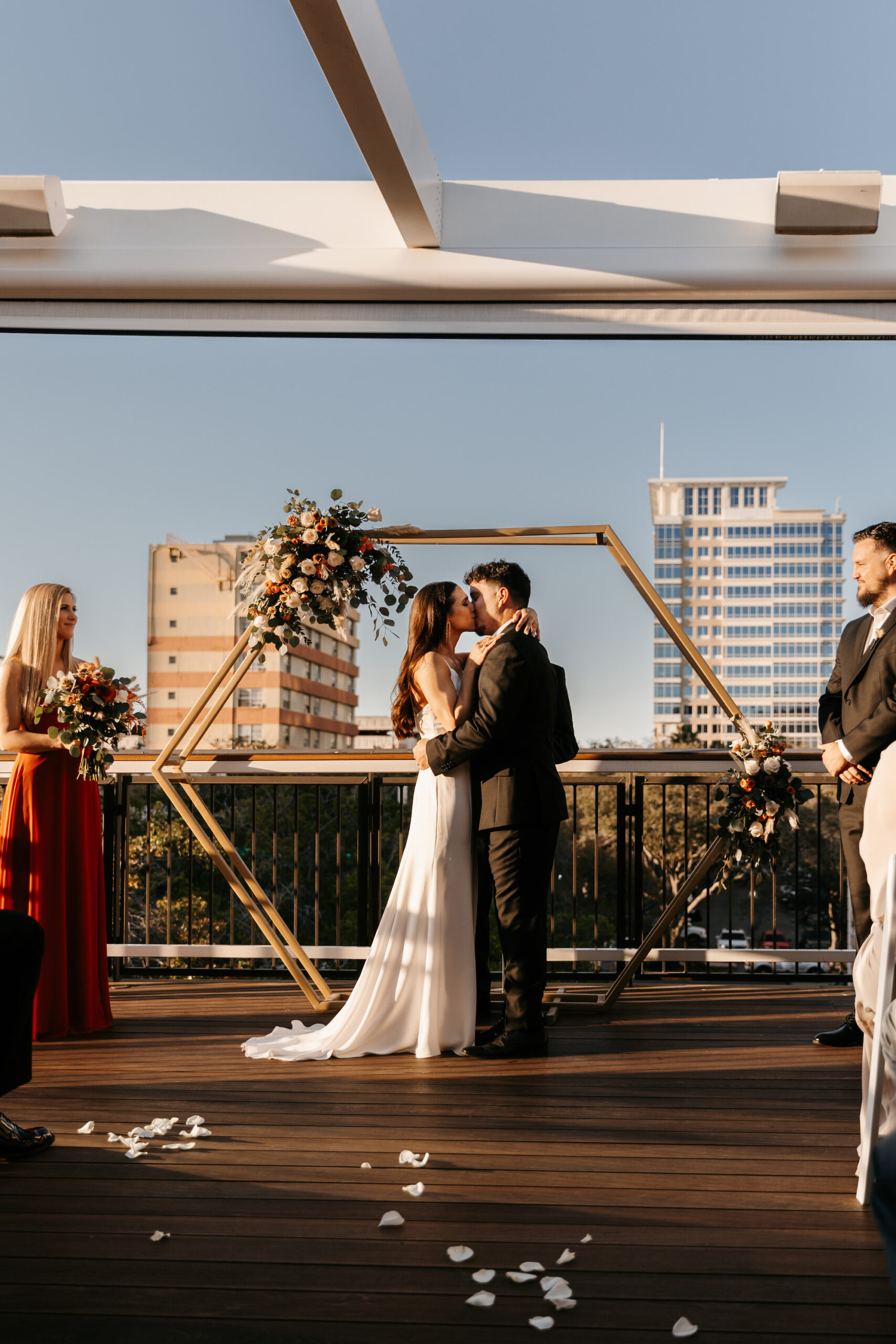 Bride and Groom Exchange Vows | Outdoor Bohemian Wedding Ceremony with Gold Arch | St. Petersburg Wedding Venue Red Mesa Events