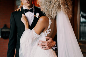 Vintage European Bride Wearing Delicate Floral Lace Straps, Off the Shoulder Tulle Puff Long Sleeves with Groom Wearing Black Tuxedo | Tampa Bay Wedding Photographer Dewitt for Love