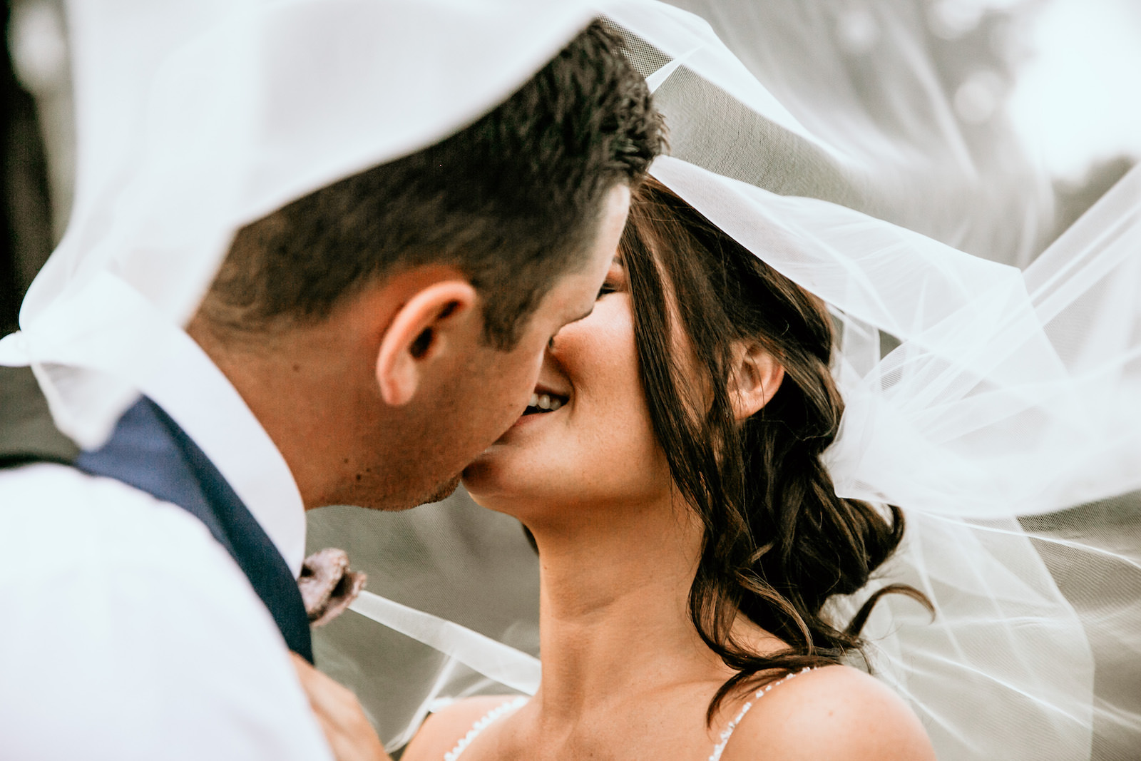 Bride and Groom Intimate Kiss Under Veil Wedding Portrait