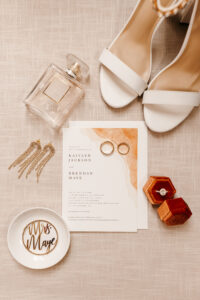 Romantic Boho Wedding Invitation with White Open Toe Heels and Engagement Ring in Burnt Orange Engagement Box