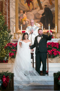 Green and Gold Christmas Wedding, Bride and Groom Exchanging Wedding Vows During Ceremony | Tampa Bay Wedding Photographer Carrie Wildes Photography | Traditional Church Wedding Venue Jesuit High School: Chapel of the Holy Cross