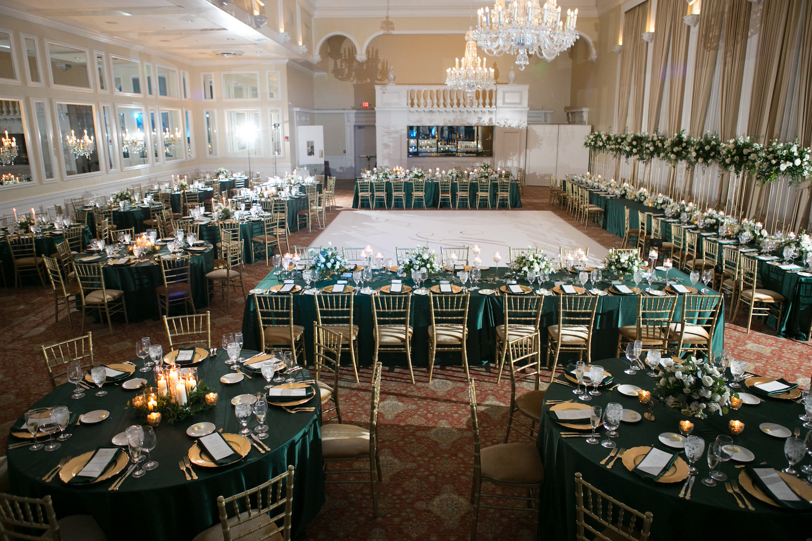Green and Gold Christmas Wedding Decor, Long and Round Tables with Emerald Green Table Linens, Gold Chiavari Chairs, Goldd Chargers, White and Greenery Low and Tall Floral Centerpieces | Tampa Bay Wedding Photographer Carrie Wildes Photography | Wedding Rentals Kate Ryan Event Rentals | Over the Top Rental Linens | A Chair Affair Event Rentals | Tampa Wedding Venue Palma Ceia Golf & Country Club