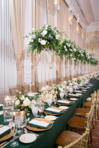 Green and Gold Christmas Wedding Decor, Long and Round Tables with Emerald Green Table Linens, Gold Chiavari Chairs, Gold Chargers, White and Greenery Low and Tall Floral Centerpieces, Gold Monogram on Dance Floor | Tampa Bay Wedding Photographer Carrie Wildes Photography | Wedding Rentals Kate Ryan Event Rentals | Over the Top Rental Linens | A Chair Affair Event Rentals | Tampa Bay Wedding Venue Palma Ceia Golf & Country Club