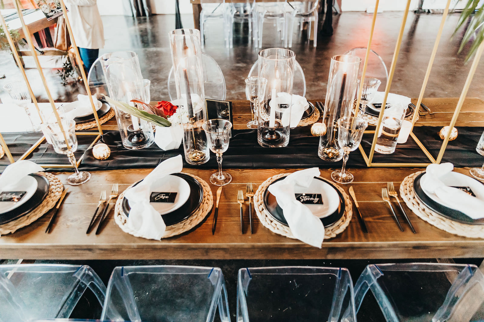 Black Plating with Woven Chargers and Gold Flatware | Black Acrylic Table Numbers | Gabro Event Rental Services