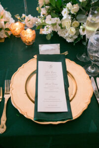 Green and Gold Christmas Wedding Reception Decor, Gold Charger, Emerald Green Linens, White Menu | Tampa Bay Wedding Photographer Carrie Wildes Photography | Wedding Rentals Kate Ryan Event Rentals | Over the Top Rental Linens | A Chair Affair |