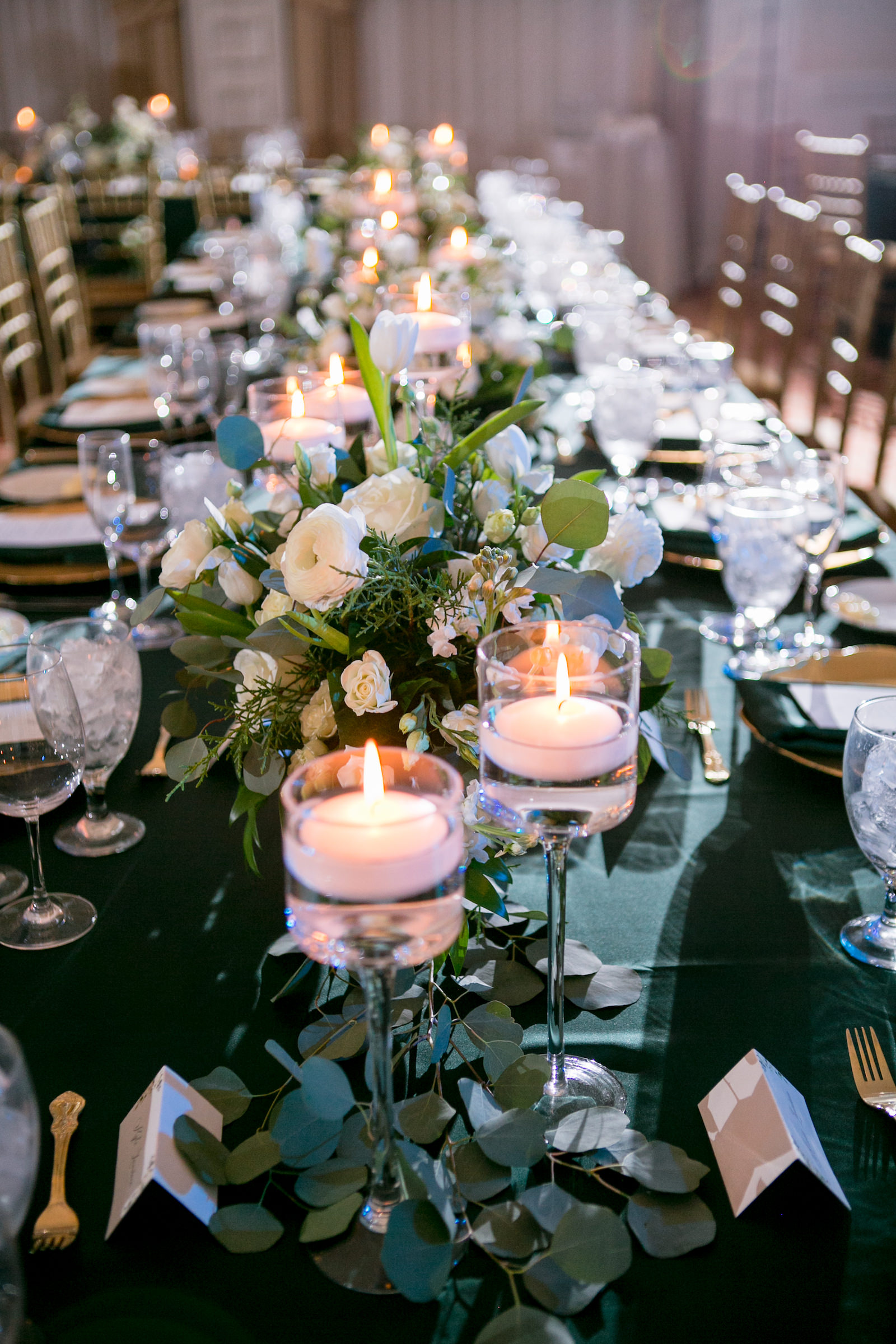 Green and Gold Christmas Wedding Decor, Long and Round Tables with Emerald Green Table Linens, Gold Chiavari Chairs, Gold Chargers, White and Greenery Low and Tall Floral Centerpieces, Gold Monogram on Dance Floor | Tampa Bay Wedding Photographer Carrie Wildes Photography | Wedding Rentals Kate Ryan Event Rentals | Over the Top Rental Linens | A Chair Affair Event Rentals | Tampa Bay Wedding Venue Palma Ceia Golf & Country Club