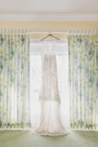Lace Illusion Wedding Dress Hanging in the Window Wedding Portrait