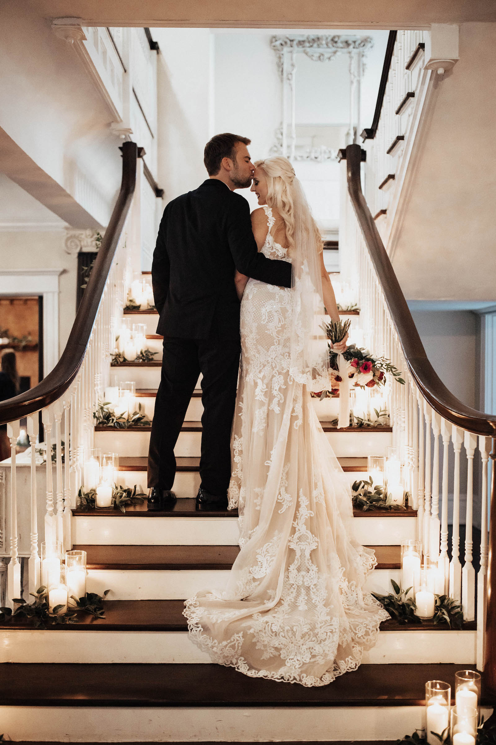 Warm Neutral Wedding, Bride and Groom Walking Up Staircase Lined with Candles | Tampa Bay Wedding Planner Coastal Coordinating | Wedding Venue The Orlo