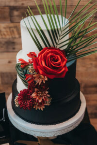 Three Tier Black and White Modern Cake with Tropical Greenery and Red Rose Detail | Tampa Florida Caterer Amici’s Catered Cuisine, Inc.