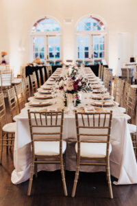 Warm Romantic Neutral Wedding Reception Decor, Long Feasting Table, Gold Chiavari Chairs, Berry, Blush Pink and Ivory Floral Centerpieces, Gold Chargers | Tampa Bay Wedding Planner Coastal Coordinating | Wedding Rentals Kate Ryan Event Rentals, Over the Top Linens | Wedding Venue The Orlo