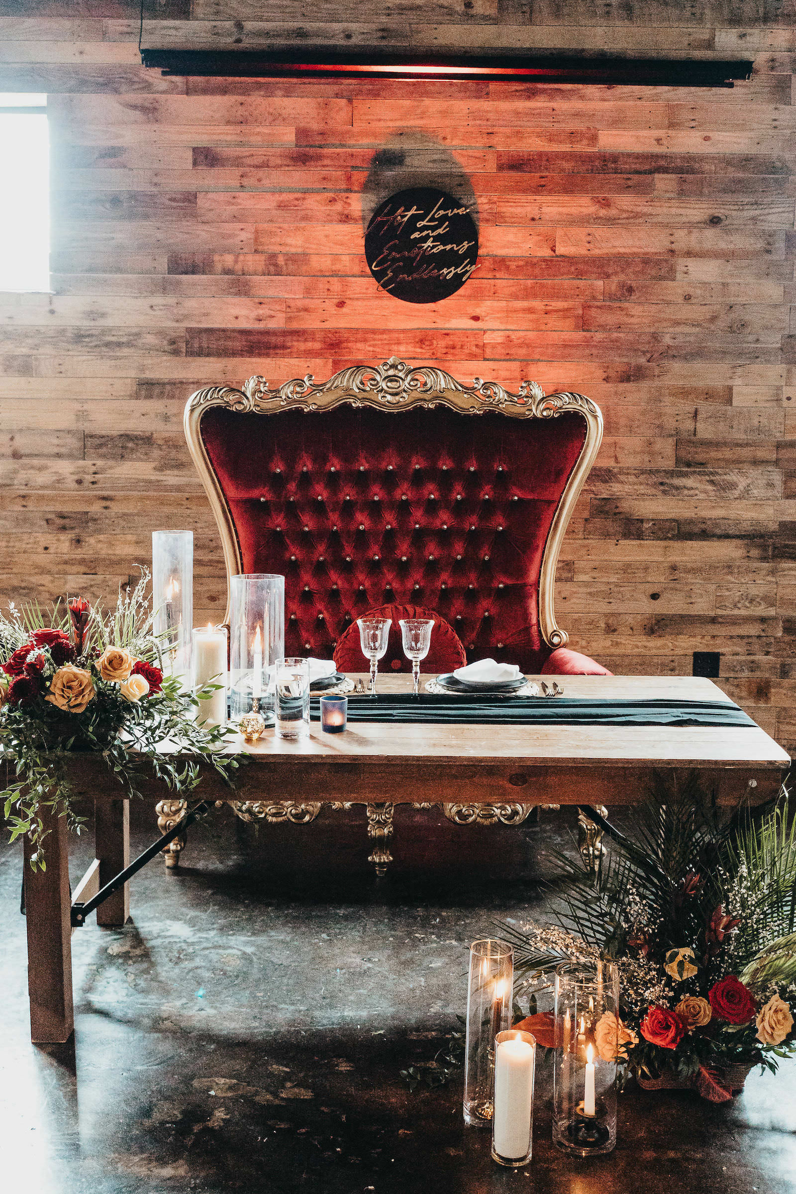 Modern Sweetheart Table with Red Velvet Loveseat Greenery and Floral Details | Gabro Event Rental Services