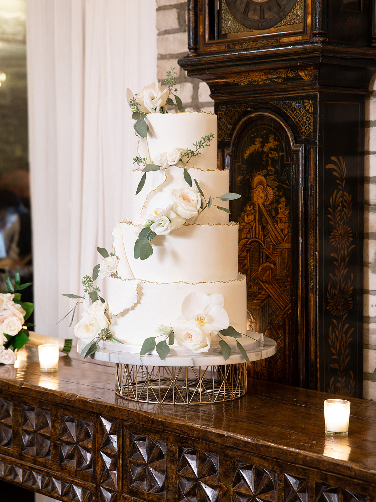 Classic White Four Tier Wedding Cake with White Roses and Orchids