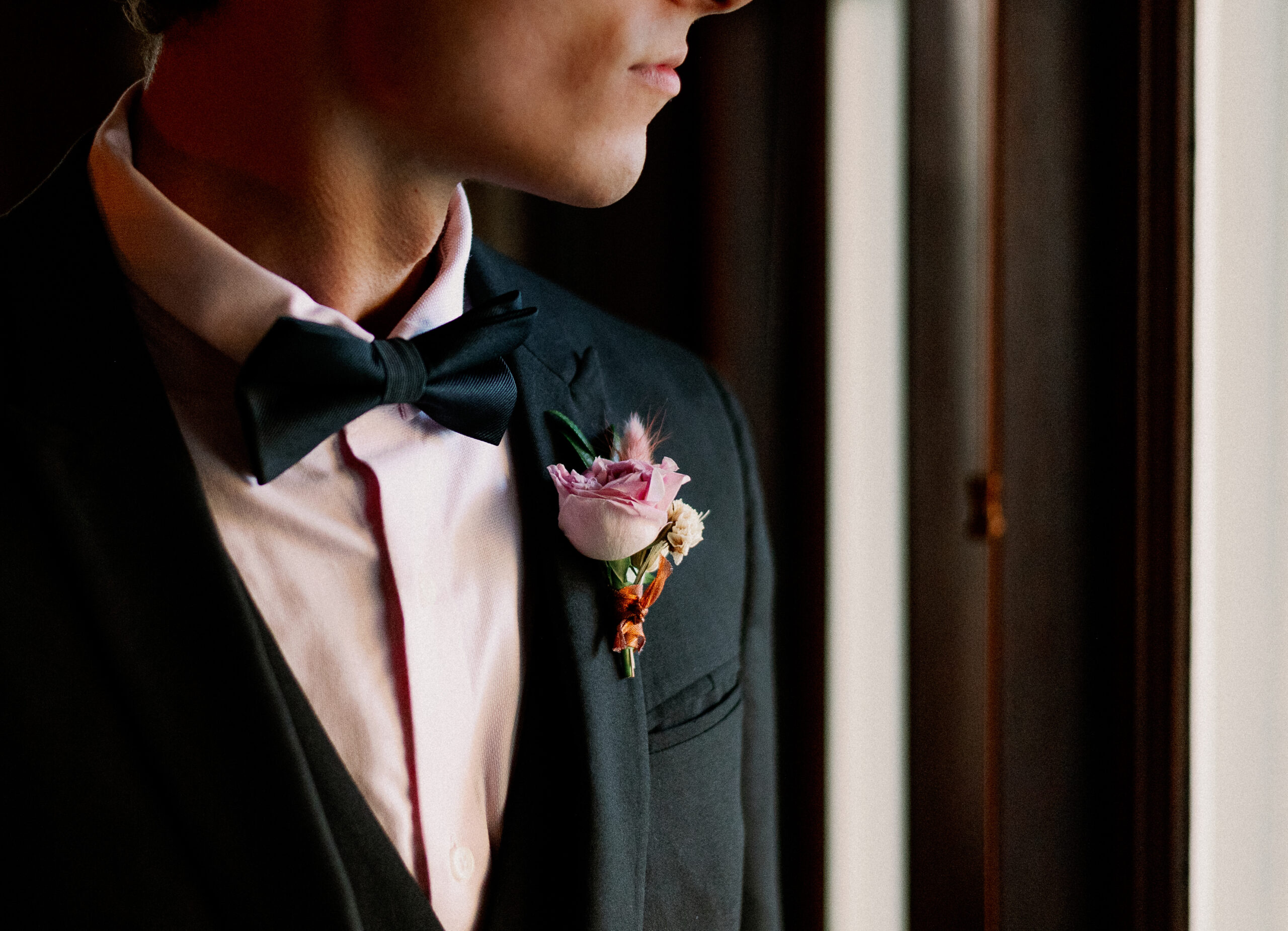 Groom Wearing Black Tuxedo and Bowtie, Pink Dress Shirt, Pink Rose Boutonniere | Tampa Bay Wedding Photographer Dewitt for Love
