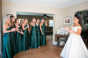 Green and Gold Christmas Wedding, Bridesmaids Wearing Matching One Shoulder Emerald Green Dresses First Look Wedding Portrait | Tampa Bay Wedding Photographer Carrie Wildes Photography | Bella Bridesmaids