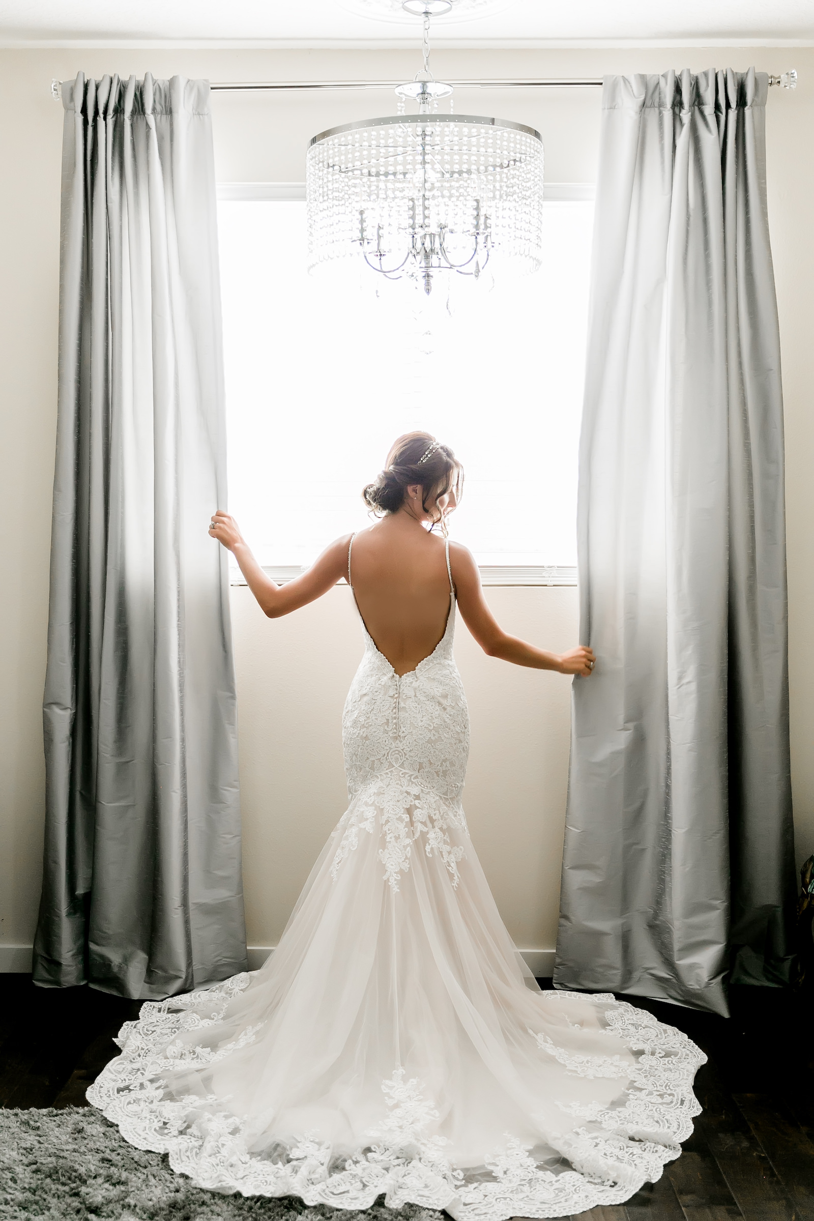 Bride Getting Ready in Backless Long Train Wedding Gown Wedding Portrait | Curled Updo with Elegant Makeup | Tampa Wedding Hair and Makeup Artist Adore Bridal