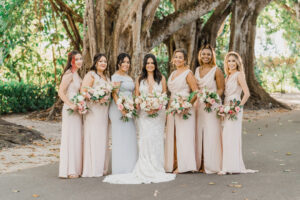 Bride and Bridesmaids in Pastel Floor Length Bridesmaids Dresses in Tropical Wedding Ceremony