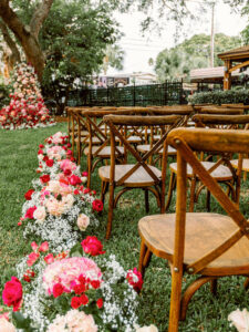 Fairytale Red and Pink Wedding Ceremony Decor, Wooden Cross Back Chairs, Red and Pink Lush Altar Flowers | Tampa Bay Wedding Photographer Dewitt for Love Photography | Wedding Florist Lemon Drops