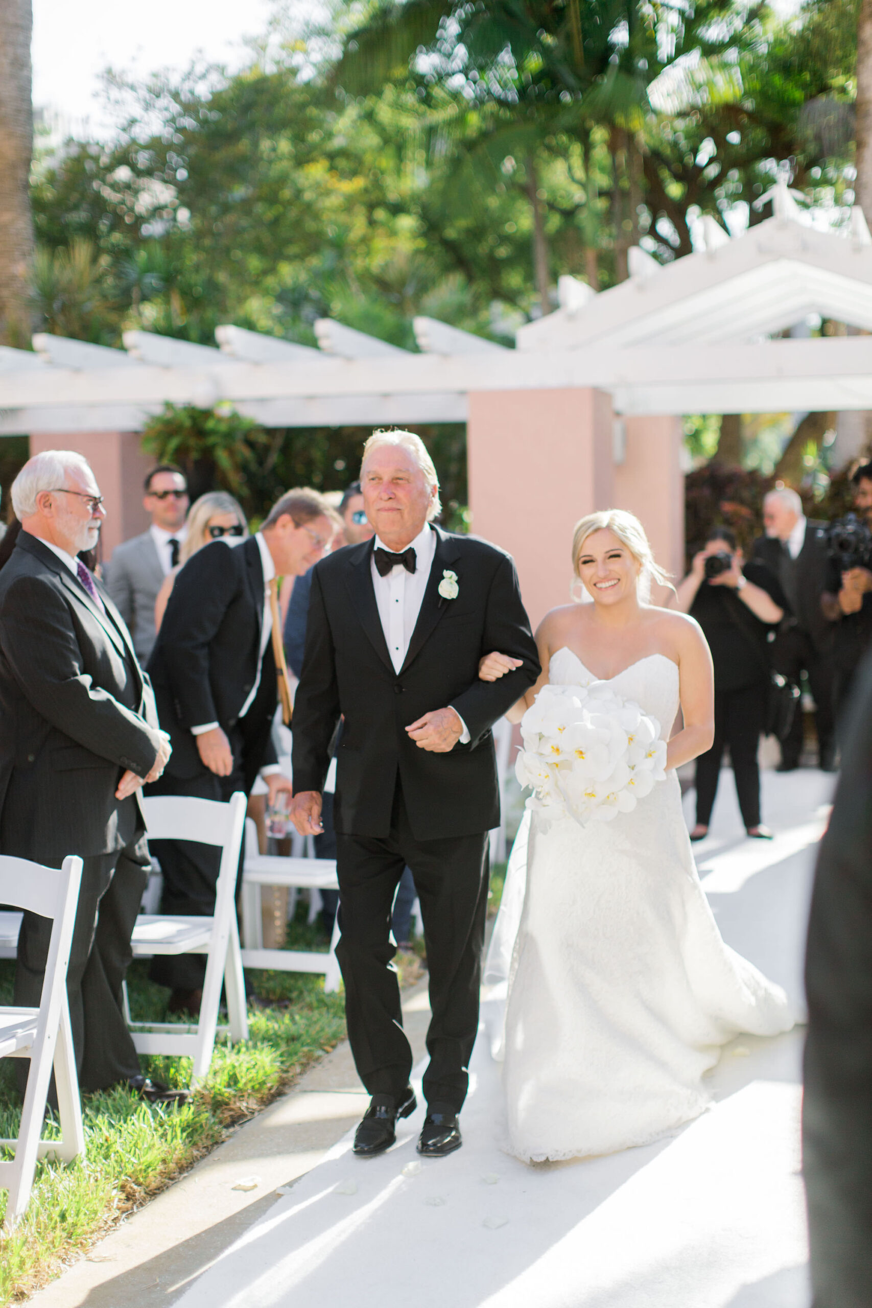 Timeless Classic Wedding Ceremony, Bride Walking Down the Aisle with Father Holding White Orchid Floral Bouquet | Tampa Bay Wedding Florist Bruce Wayne Florals