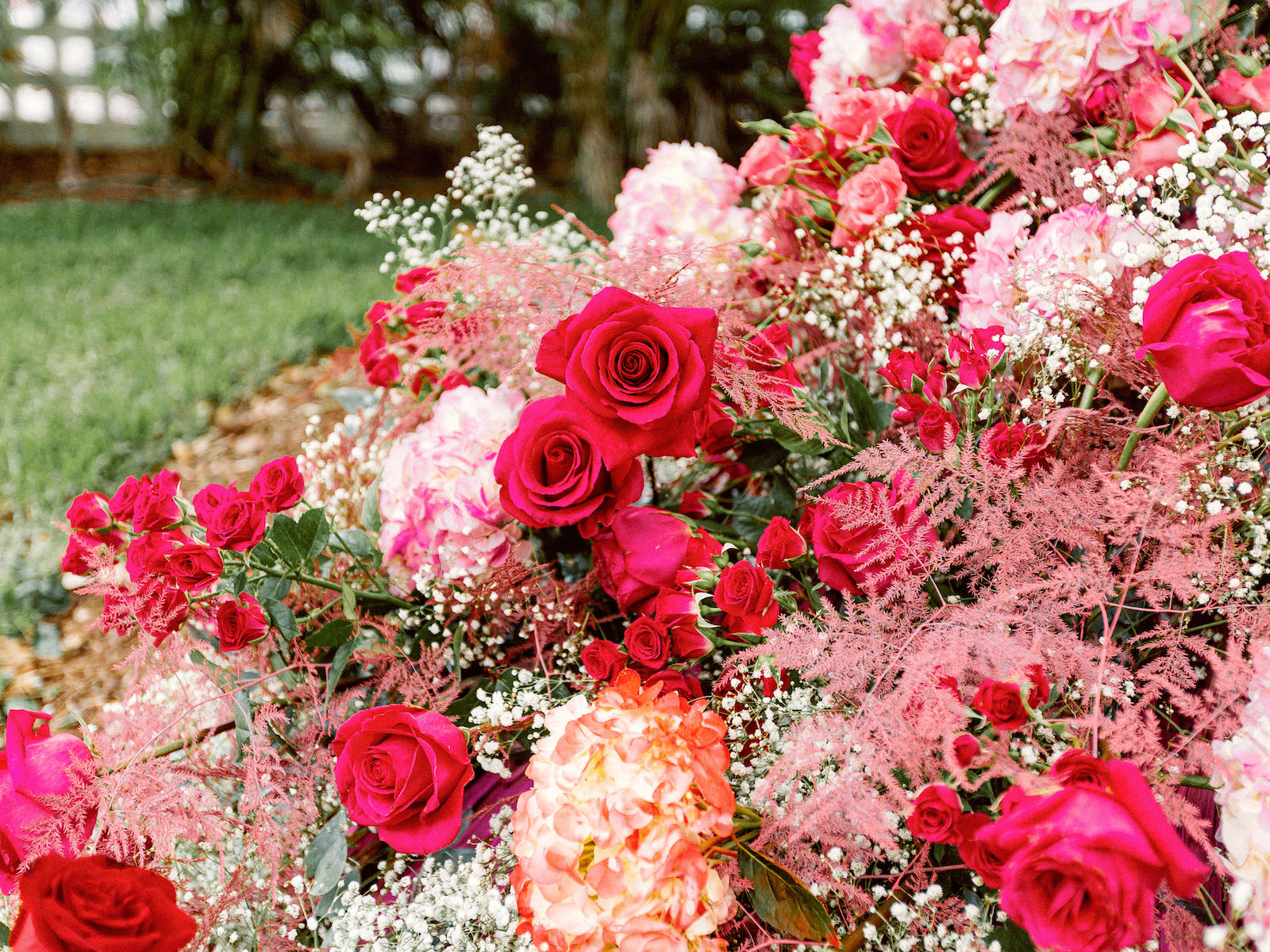 Fairytale Wedding Ceremony Decor, Lush Red, Pink Roses, Hydrangeas, Altar Flower Arrangement | Tampa Bay Wedding Photographer Dewitt for Love Photography | Wedding Florist Lemon Drops