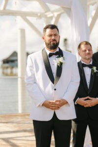 Tropical Modern Wedding, Groom Wearing White and Black Tuxedo Watching Bride Walking Down the Aisle