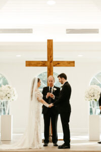 Bride and Groom Exchange Vows in Timeless Neutral White and Black Safety Harbor Chapel Wedding Ceremony | Harborside Chapel