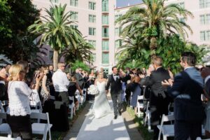 Timeless Classic Bride and Groom Exchanging Wedding Vows During Courtyard Wedding Ceremony | St. Pete Wedding Venue The Vinoy Renaissance | Wedding Planner Parties A La Carte