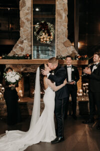 Bride and Groom First Kiss in Dark and Moody Industrial Wedding Ceremony | Florida Wedding Venue Urban Stillhouse