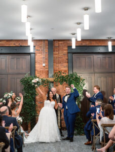 Wedding Ceremony Greenery Arch | Modern Industrial Downtown Tampa Wedding Venue Armature Works Social Room