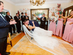 Fairytale Red and Pink Private Residence Wedding, Groom Dip Kissing Bride During Wedding Ceremony | Tampa Bay Wedding Photographer Dewitt for Love Photography