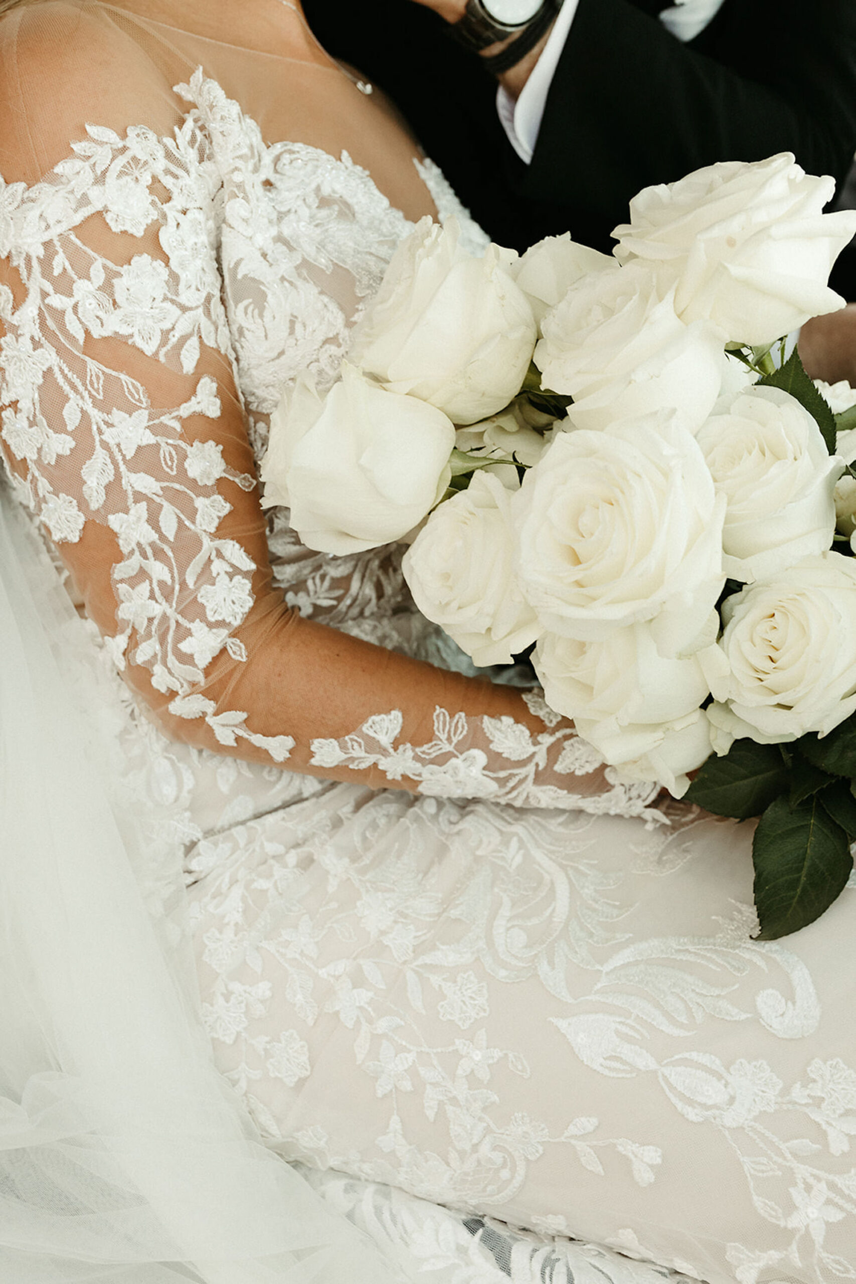 Bride in Long Sleeve Lace Sheer Wedding Dress with White Peony Bouquet