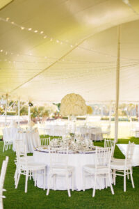 Modern Elegant Outdoor Tent Wedding Reception Decor, White Chiavari Chairs, Tall White Floral Centerpieces, Hanging String Lights | Tampa Bay Wedding Venue The Resort at Longboat Key Club