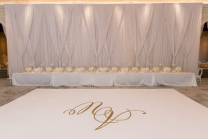 Timeless Classic Wedding Reception Decor, White Dance Floor with Gold Monogram, White Curtain Draping, Long Head Table with White Linens and White Flowers, Candlesticks | Tampa Bay Wedding Planner Parties A'la Carte | St. Pete Wedding Venue The Vinoy Renaissance | Wedding Florist Bruce Wayne Florals